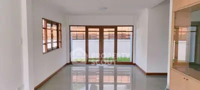 Spacious living room with large windows and glossy floor in modern home
