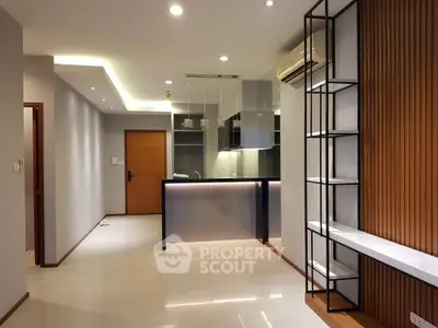Modern open-plan living room with sleek kitchen and stylish lighting