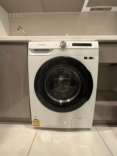 Modern kitchen with sleek washing machine under counter