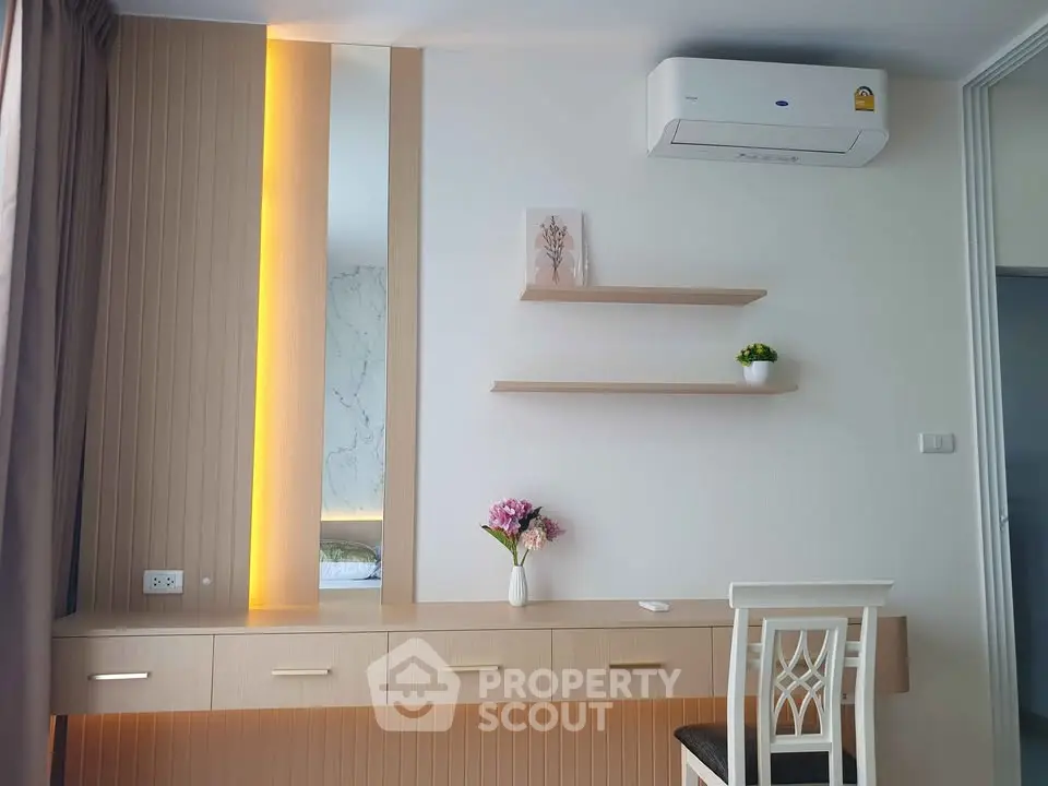 Modern study area with stylish desk, shelves, and air conditioning in a contemporary home.