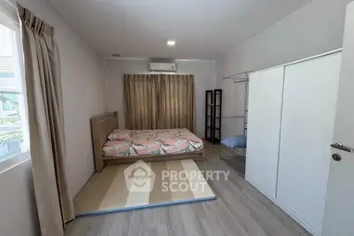 Spacious bedroom with modern decor and ample natural light