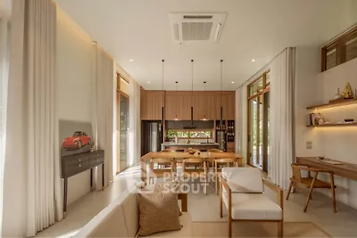 Luxurious open-plan living and dining area with modern decor and natural light.