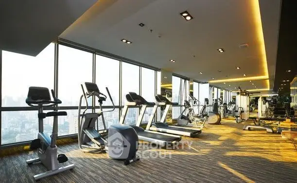 Luxurious high-rise gym with panoramic city views and modern fitness equipment.