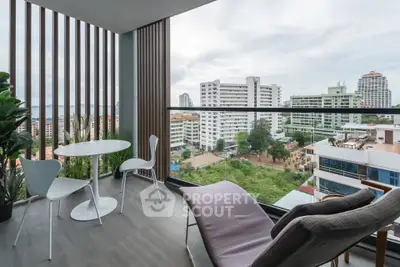 Modern balcony with stunning city view and stylish outdoor furniture