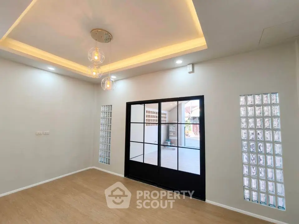 Modern living room with elegant lighting and glass panel doors