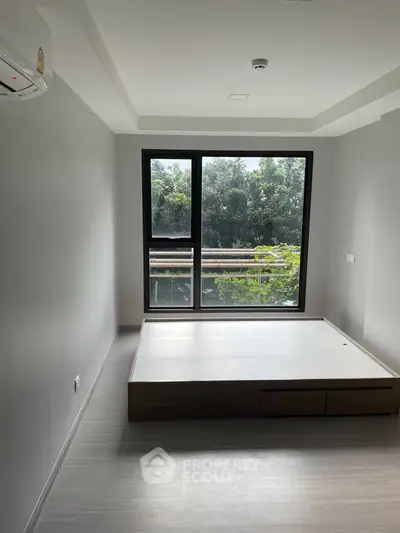 Modern minimalist bedroom with large window and built-in bed frame