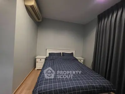 Cozy bedroom with modern decor and air conditioning, perfect for restful nights.