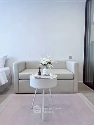 Modern living room with cozy sofa and stylish round table in elegant apartment.