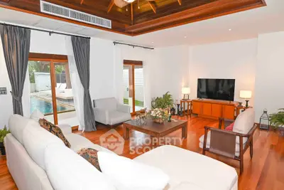 Luxurious living room with pool view, elegant wooden flooring, and modern decor in a stunning home.