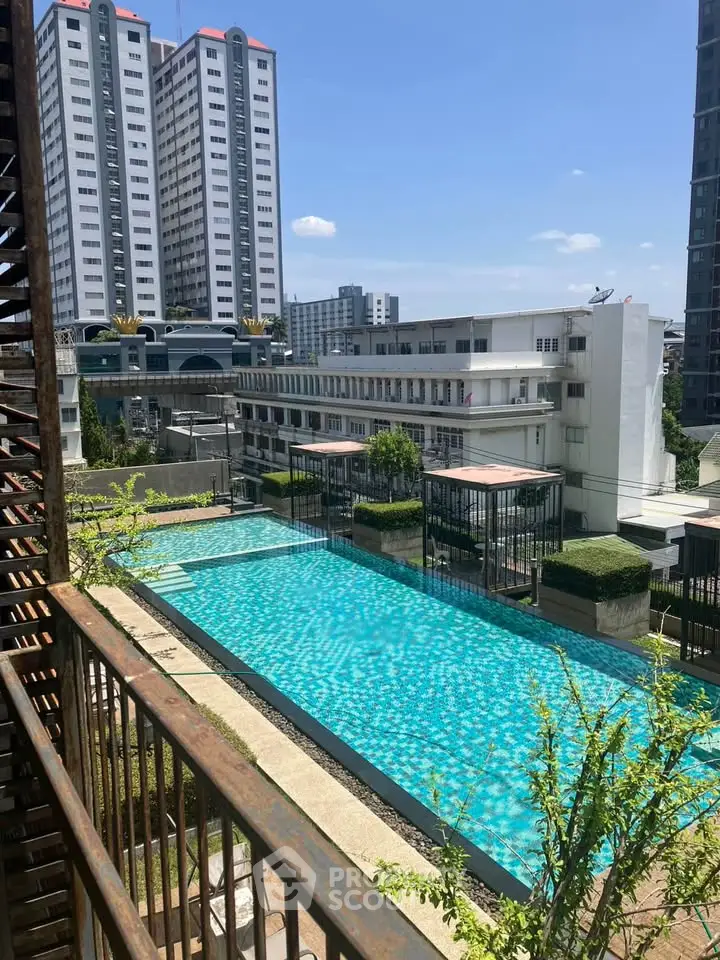 Stunning pool view from balcony in modern urban apartment complex