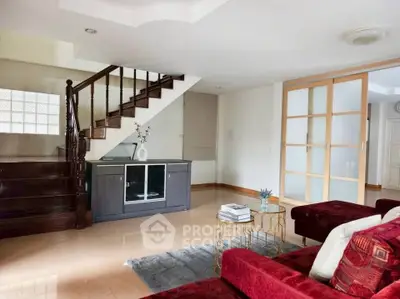 Spacious living room with elegant staircase and modern decor