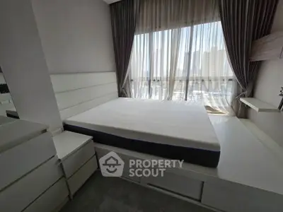 Modern bedroom with large window and stylish curtains in a high-rise apartment.