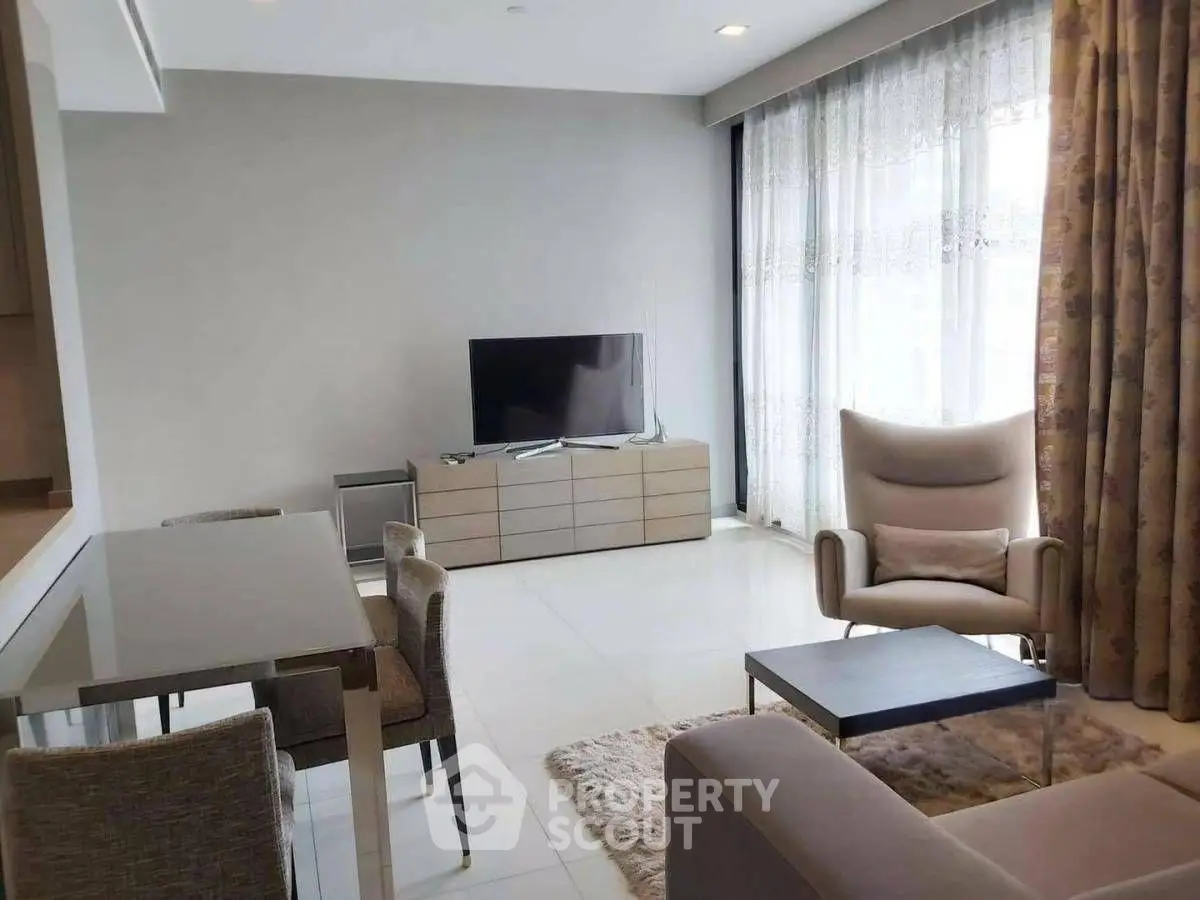 Modern living room with sleek furniture and large window for natural light.