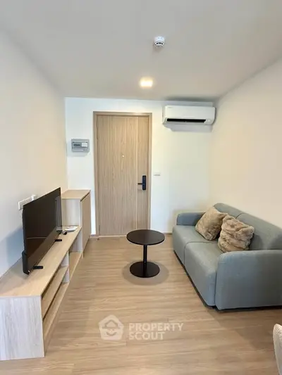 Modern living room with cozy sofa, TV, and air conditioning in a stylish apartment.