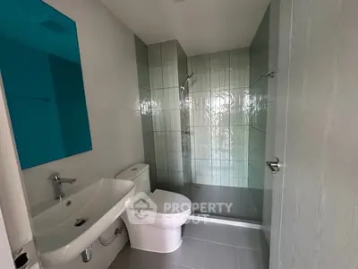 Modern bathroom with sleek fixtures and spacious shower area
