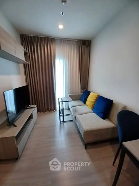 Modern living room with cozy sofa and TV, perfect for relaxation.