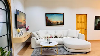 Elegant living room with modern decor, featuring a cozy sectional sofa and stylish wall art.