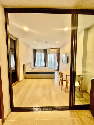 Spacious modern bedroom with large windows and stylish furnishings