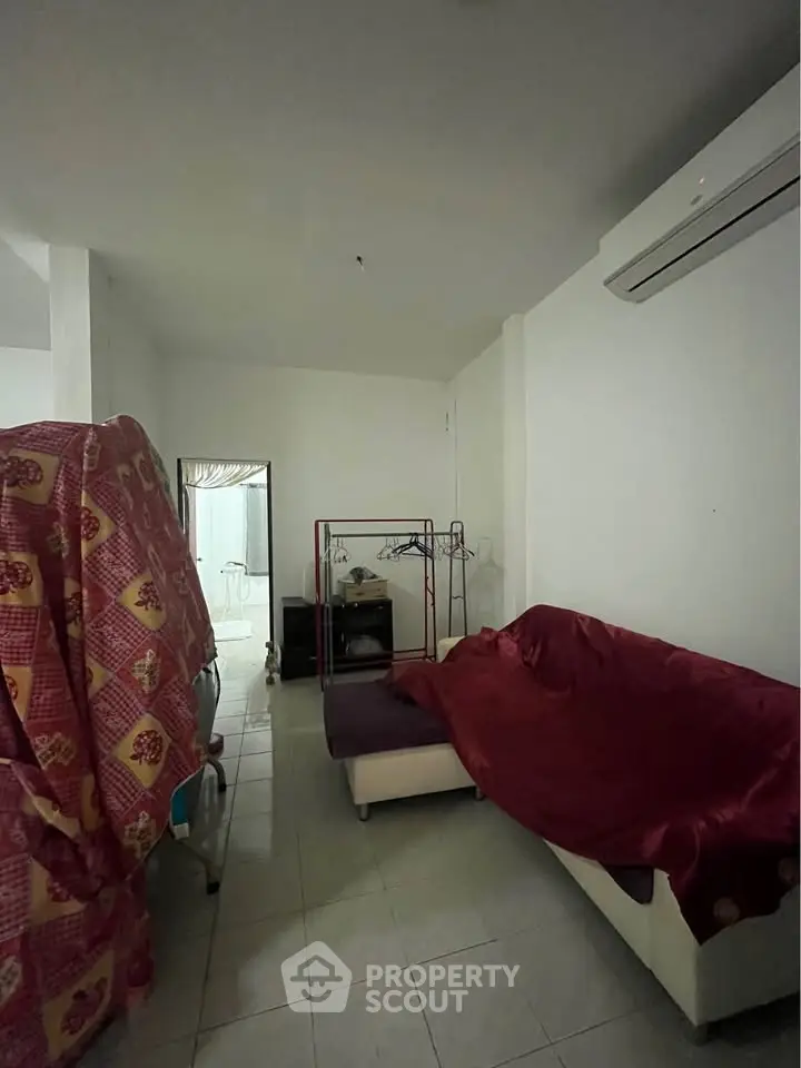 Cozy living room with air conditioning and minimalist decor, perfect for relaxation.