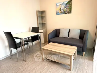 Modern living room with cozy sofa, dining table, and stylish decor