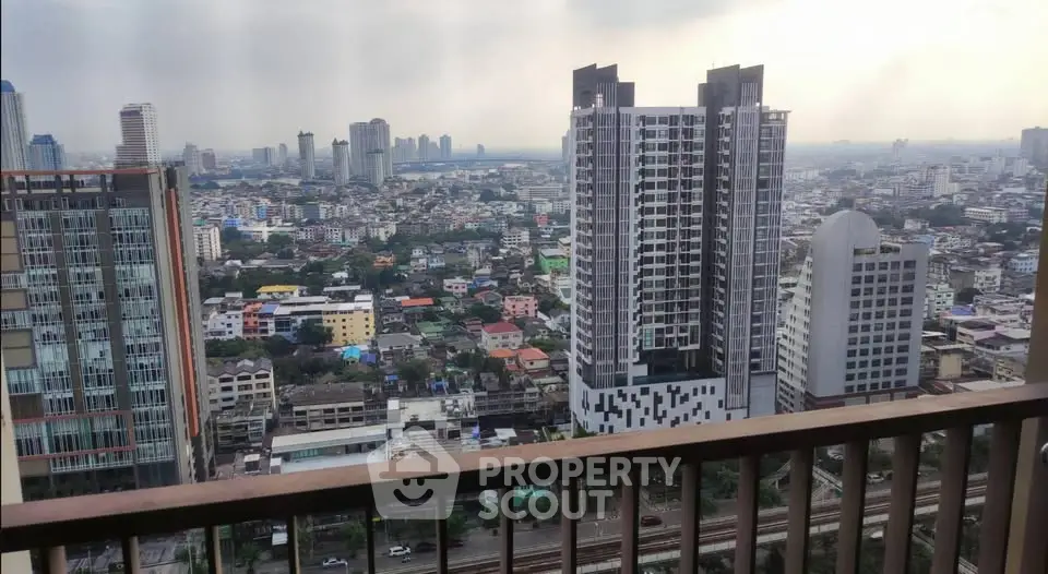 Stunning cityscape view from high-rise balcony overlooking urban skyline.