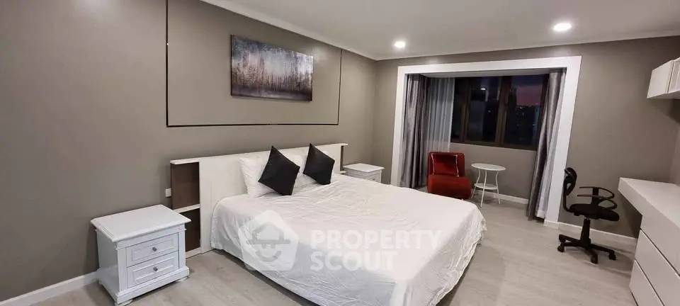 Spacious modern bedroom with elegant decor and city view