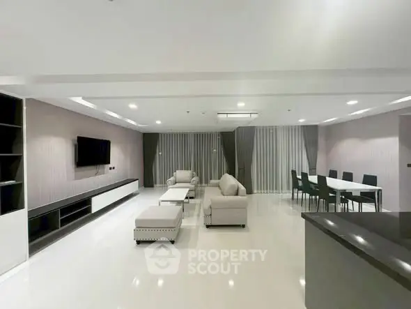 Spacious modern living room with elegant furniture and dining area, perfect for entertaining guests.