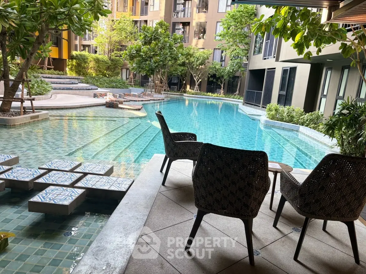 Luxurious poolside view with modern seating in a serene residential complex