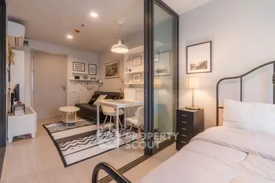 Modern studio apartment with stylish decor and open layout, featuring a cozy living area and comfortable bedroom.