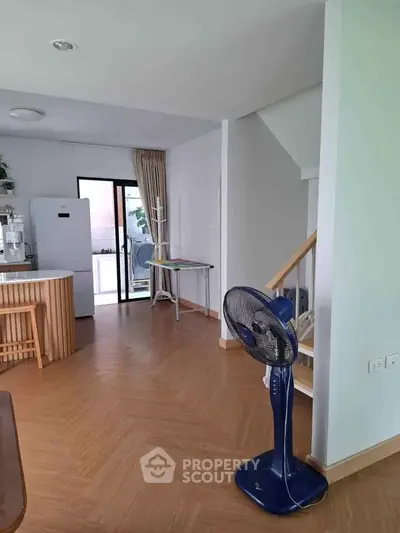 Spacious modern kitchen with open layout and wooden flooring