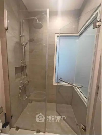 Modern bathroom with glass shower enclosure and sleek fixtures
