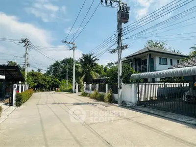 Charming suburban street with modern homes and lush greenery, perfect for peaceful living.
