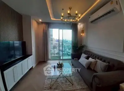 Luxurious living room with city view, elegant chandelier, and modern decor.