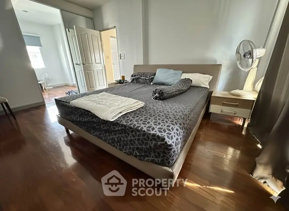 Spacious bedroom with modern decor and natural light