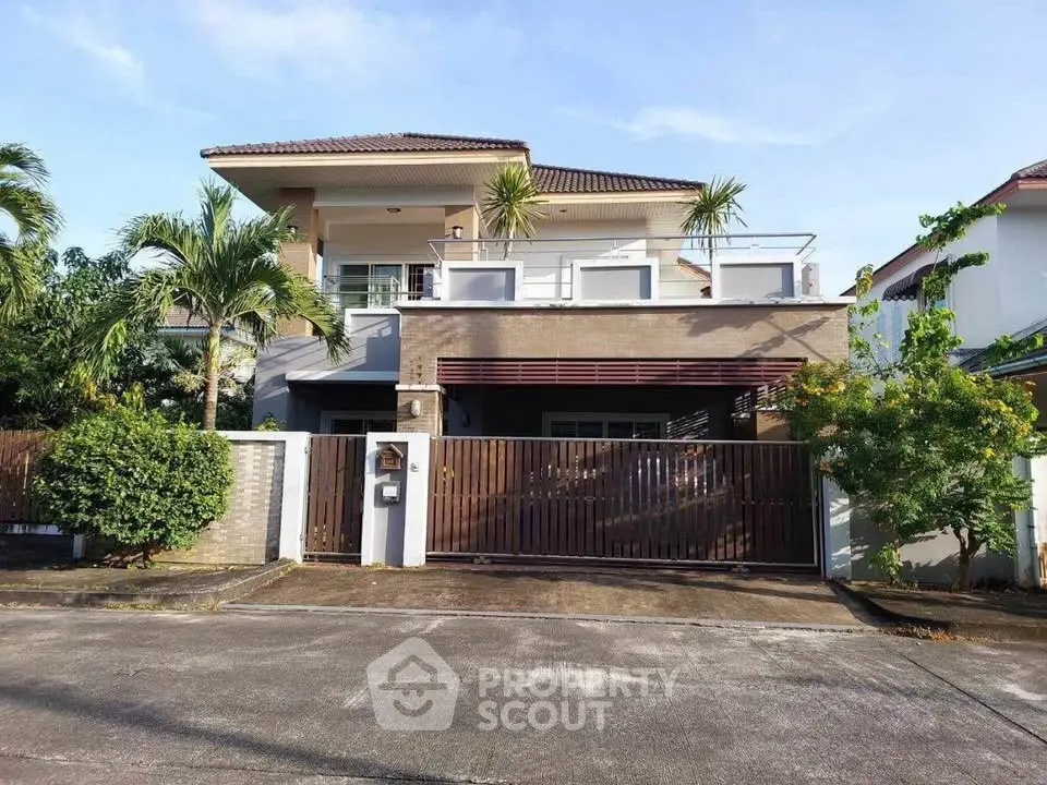 Stunning modern two-story house with lush greenery and spacious balcony in a serene neighborhood.