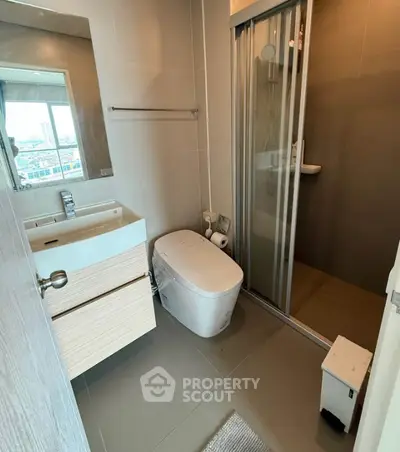 Modern bathroom with sleek fixtures and city view window, featuring a shower and contemporary design.