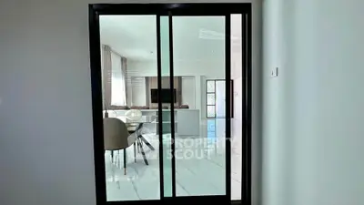 Modern interior with sliding glass doors leading to a stylish dining area.