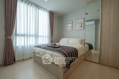 Modern bedroom with cozy bed, stylish decor, and ample natural light.