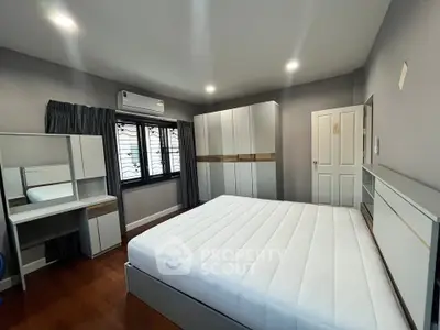 Spacious modern bedroom with sleek furniture and ample natural light