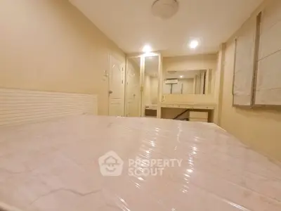 Cozy bedroom with large bed and built-in vanity mirror, perfect for relaxation.