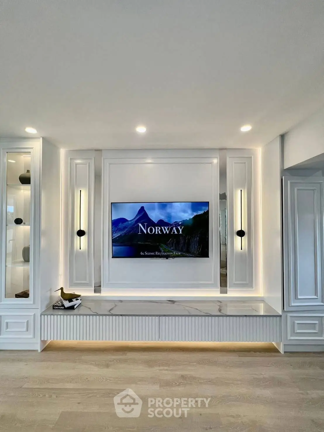 Luxurious living room with modern TV setup and elegant lighting