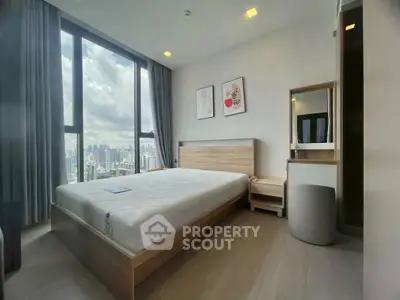 Modern bedroom with city view, large window, and minimalist decor in high-rise apartment.