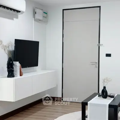 Modern living room with sleek decor and wall-mounted TV