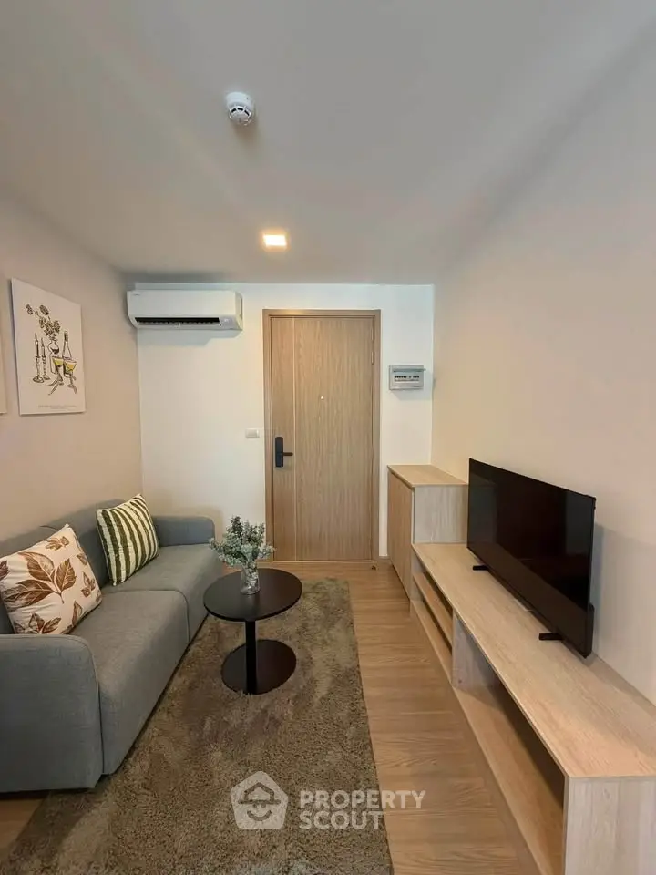 Modern living room with stylish decor and cozy seating area, perfect for relaxation.