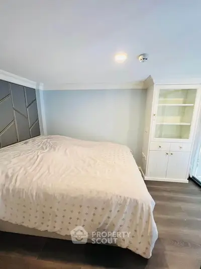 Cozy bedroom with elegant decor and built-in storage, perfect for a serene retreat.