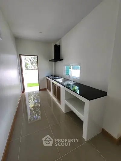 Sleek modern kitchen with glossy tiles and minimalist design