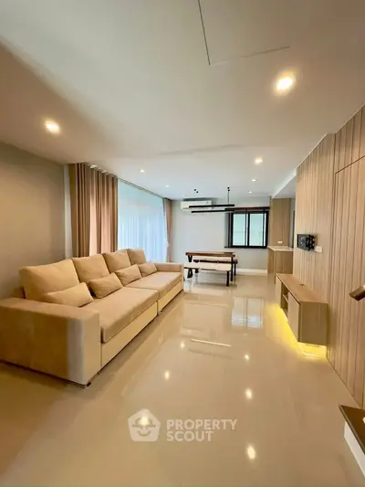 Spacious modern living room with elegant sofa and dining area