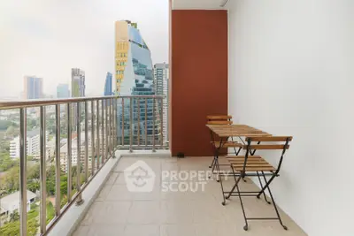 Spacious balcony with city view and modern furniture in high-rise apartment