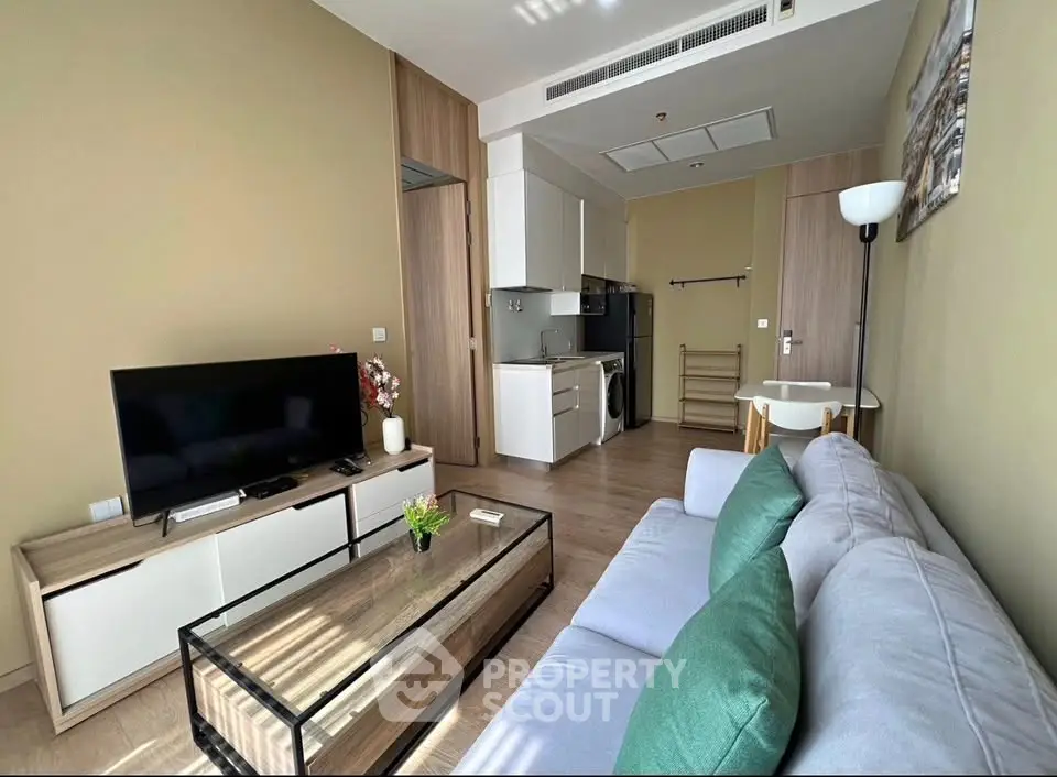 Modern living room with sleek furniture and integrated kitchen appliances