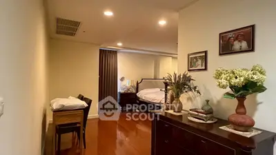 Spacious bedroom with elegant decor and wooden flooring